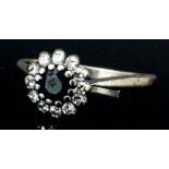 An 18ct white gold mounted sapphire and diamond cluster ring, set with central circular sapphire (
