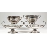 A pair of George V silver oval two-handled dishes of lobed outline with leaf and bead cast rims,