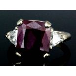 An 18ct white gold mounted ruby and diamond ring, the centre square cut ruby (approximately 3ct)