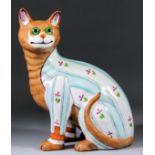 A good Galle faience figure of a seated cat wearing a stripy jacket with flower spray decoration,