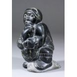 20th Century Canadian Inuit school - Carved soap stone - Eskimo holding a seal, 6ins high,