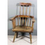 A 19th Century ash, elm and stained wood primitive two-tier stick back Windsor armchair (probably of