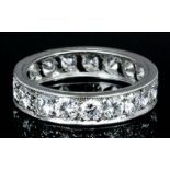 A modern silvery metal mounted diamond full hoop eternity ring, set with round brilliant cut