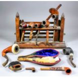 A collection of eleven pipes, and an oak novelty rack in the form of a four-bar gate, including -