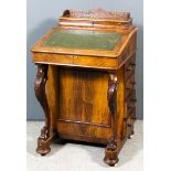 A Victorian figured walnut Davenport, the upper part with stationery rack with fretted gallery