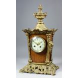 A late 19th/early 20th Century French cast brass and oak mantel clock, No. 10527 46, the 3.25ins
