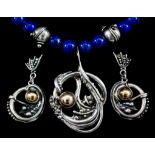 A modern silver and lapis lazuli bead necklace with silver and silver gilt pendant of abstract form,