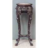 A Chinese carved rosewood octagonal jardiniere stand, the top inset with red veined marble and