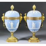 A good pair of early19th Century ormolu mounted Wedgwood blue Jasperware urns and covers, the bodies