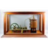 A brass and wood scratch built model of a static steam engine, 14.5ins high, in glazed mahogany