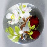 A German art glass paperweight by Stefan Bracht, of berries and blossom on a branch, with an "SB"