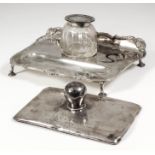 A George V silver rectangular inkstand with shaped, moulded and shell cast rim, on four hoof pattern