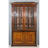 A late 19th Century mahogany bookcase with deep moulded cornice and rounded front corners with