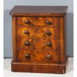 A Victorian mahogany miniature chest with rounded front corners, fitted four long drawers, on plinth