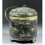 A Chinese bronze and parcel gilt cylindrical basket and domed cover, the pierced cover and sides