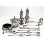 Two George III silver pepper pots, the domed lids with various finials, bulbous bases on circular