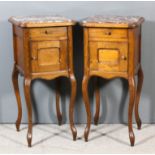 A pair of French oak bedside cabinets with moulded edge to top and inset with red flecked marble