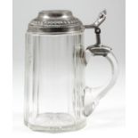 A German silvery metal mounted and cut glass tankard, the mounts with bead ornament, leaf and scroll