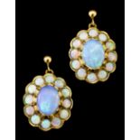 A pair of 9ct gold mounted opal cluster earrings (for pierced ears), set with central oval opal (