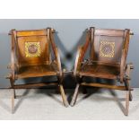 Two late Victorian oak "Glastonbury" oak armchairs, the panelled backs with carved and gilded square