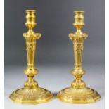 A pair of 19th Century French ormolu pillar candlestick of "Louis XVI" design, the columns crisply