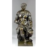 A 19th Century Continental (after the Antique) green patinated bronze seated figure of a Roman