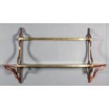 A 19th Century rosewood and brass mounted bow fronted two-tier wall shelf of shaped outline with