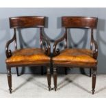 A pair of William IV mahogany armchairs with deep moulded and curved crest rails and scroll arms,