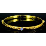 A modern 18ct gold mounted and opal stiff bangle, the face set with four opals (each