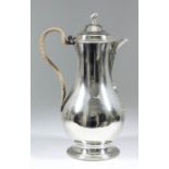 A George III silver baluster shaped coffee jug/hot water jug with plain body, the domed cover with