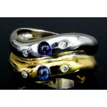 An 18ct yellow and white gold mounted sapphire and diamond ring, the twin bands each set with a