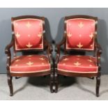 A pair of 19th Century French Empire mahogany framed open armchairs with moulded and slightly arched