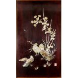 A Japanese shibayama panel of doves, bamboo and flowering sprays on a brown lacquer ground, with