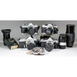 A collection of cameras, lenses and accessories, including - a Canon AE-1, body with 28mm lens, a