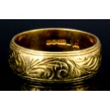 A 22ct gold wedding band engraved with leaf scroll ornament (size U+ - weight 10.4 grammes)