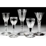 Five 18th Century drinking glasses - a wine glass with drawn trumpet bowl, air twist stem and