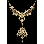 An 15ct gold mounted seed pearl and ruby flower pattern necklace with detachable additional drop/