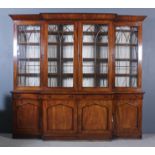 A Victorian mahogany break front bookcase, the upper part with deep cornice, fitted twelve shelves