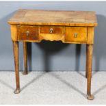 A walnut and oak lowboy of 18th Century design, the quarter veneered top with deep crossbanding,