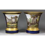 A good pair of early 19th Century French porcelain cachepots and stands, each decorated with reserve