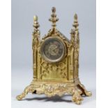 A 19th Century gilt brass cased mantel timepiece in the Gothic manner, the 1.5ins diameter