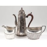 A late Victorian silver octagonal coffee pot of tapered form and with domed cover with turned