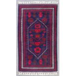 A modern Turkish rug of Beluch pattern woven in navy blue, dark red and ivory with a central stepped