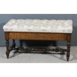 A late Victorian walnut rectangular duet stool with upholstered lifting seat, plain apron and on