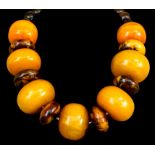 A single strand of "ethnic" style beads, including wood and reconstituted butterscotch amber,