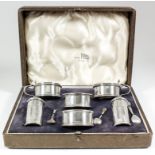 A George VI silver circular six-piece condiment set with moulded rims and footrims, comprising -