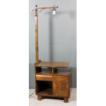 A figured walnut standard lamp/occasional table, the square upright with single branch, the table