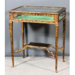 An early 20th Century painted tortoise shell effect rectangular display table with shaped panel to