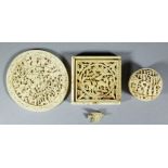 A Chinese "Cantonese" ivory circular disc (or bowl) finely carved with figures in a garden scene,