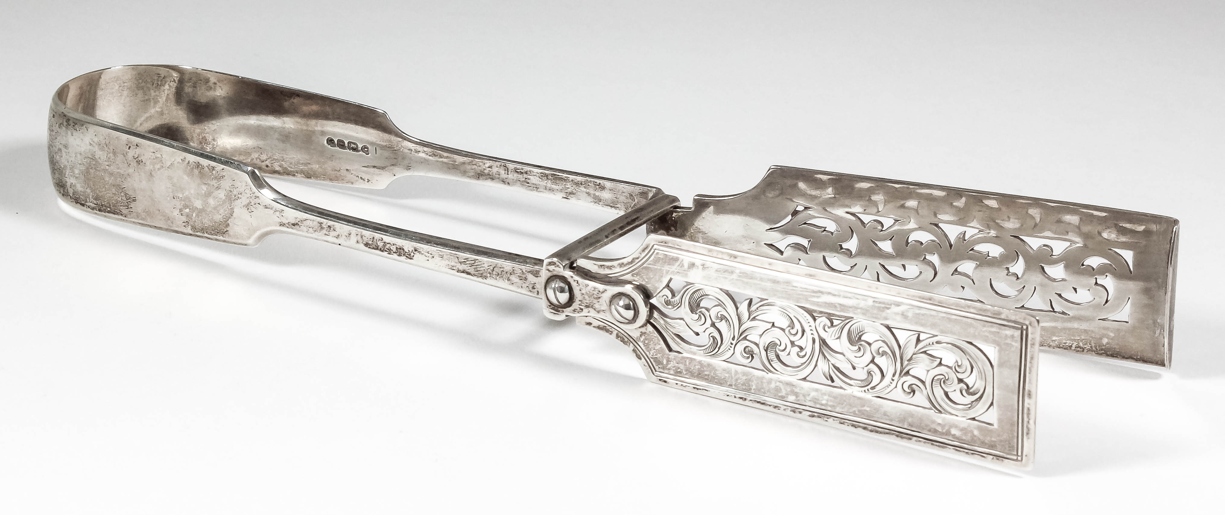 A pair of Victorian silver asparagus servers with pierced blades, by Elizabeth Eaton, London 1848 (